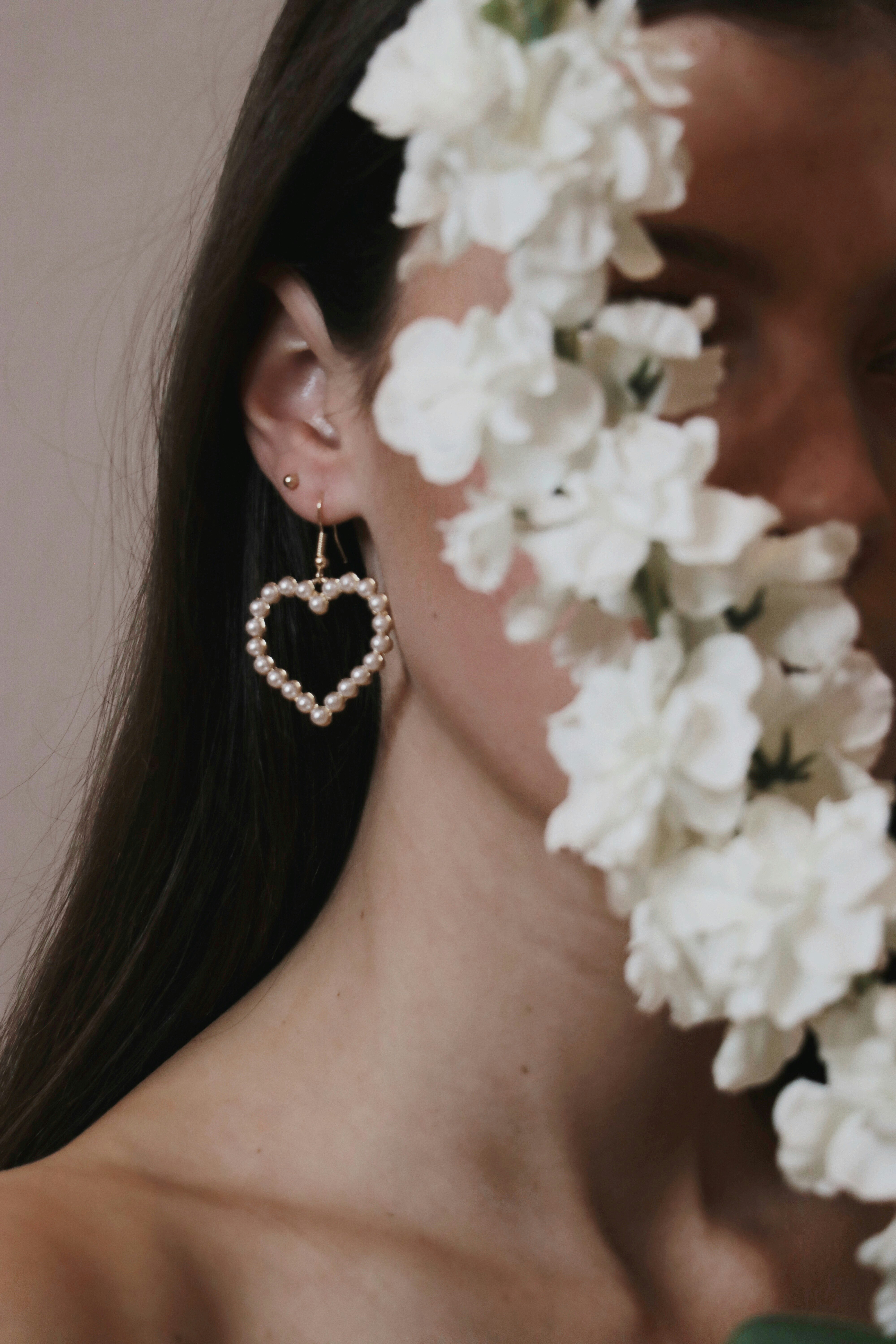 woman with white flower on her ear